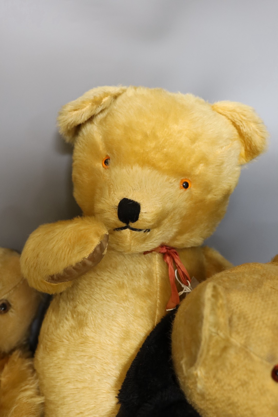 A large 1960's mohair bear, 75cm, a Chiltern 1930's bear, 50cm, and an English bear, dressed in bikers jacket and shirt, 54cm.